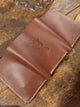 Brown leather trifold wallet.