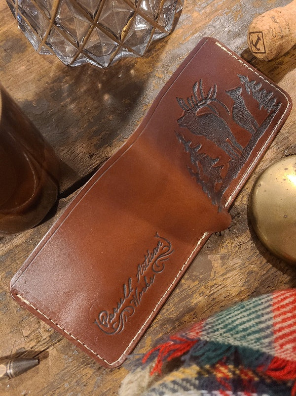 Brown leather wallet with tooled elk scene
