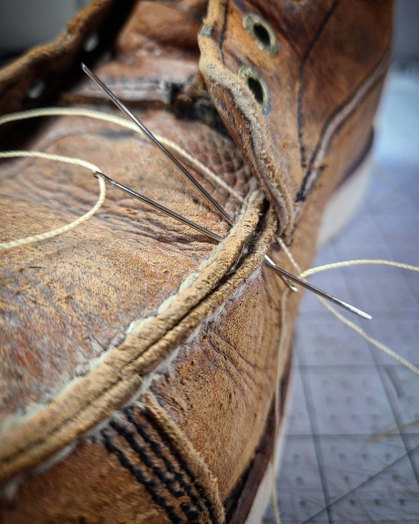 Leather goods repair in Alpena, Michigan. Leather repair shop fixing blown stitching on boots.
