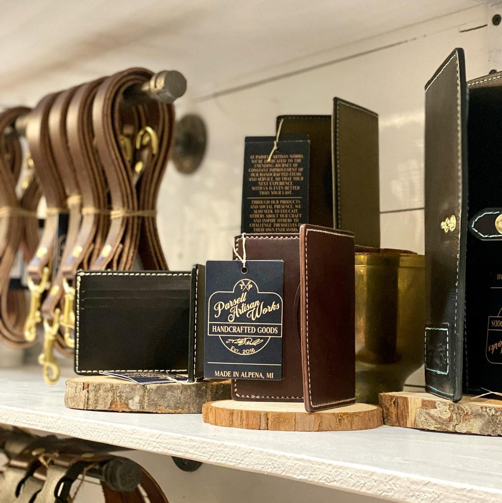 Wholesale leather belts, wallets and dog leashes on a shelf